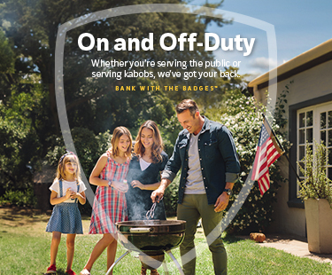 Family having a barbecue in their yard.